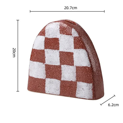 A geometric check ceramic money box with red and white checkered textured surface for living room decorbites decor