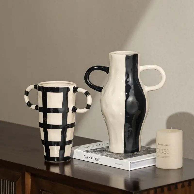 Black and white ceramic vases with geometric check pattern and vertical stripe design for living room decor