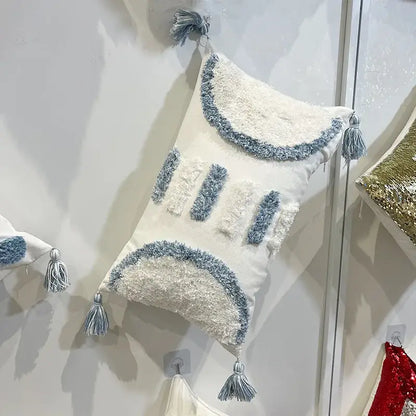 Cream-colored decorbites geometric diamond tufted pillow with blue and white fringe accents for living room decor