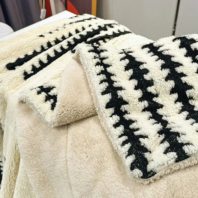 Cream-colored cream double layer lamb fleece blanket with black houndstooth pattern and soft textured surface for bedroom throw