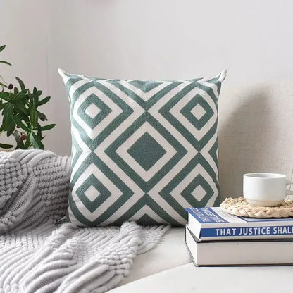 Square cushion cover with teal and white geometric embroidered pattern featuring textured decorbites embroidery for living room decor