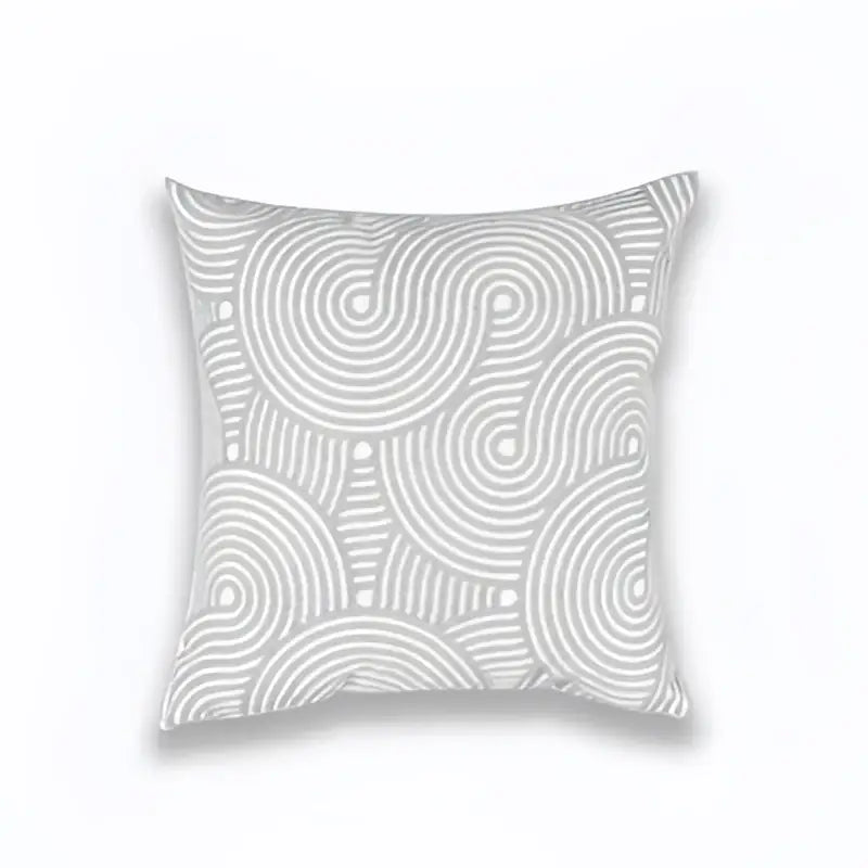 A square light grey cotton cushion cover with geometric embroidered white swirls and dots for living room decor
