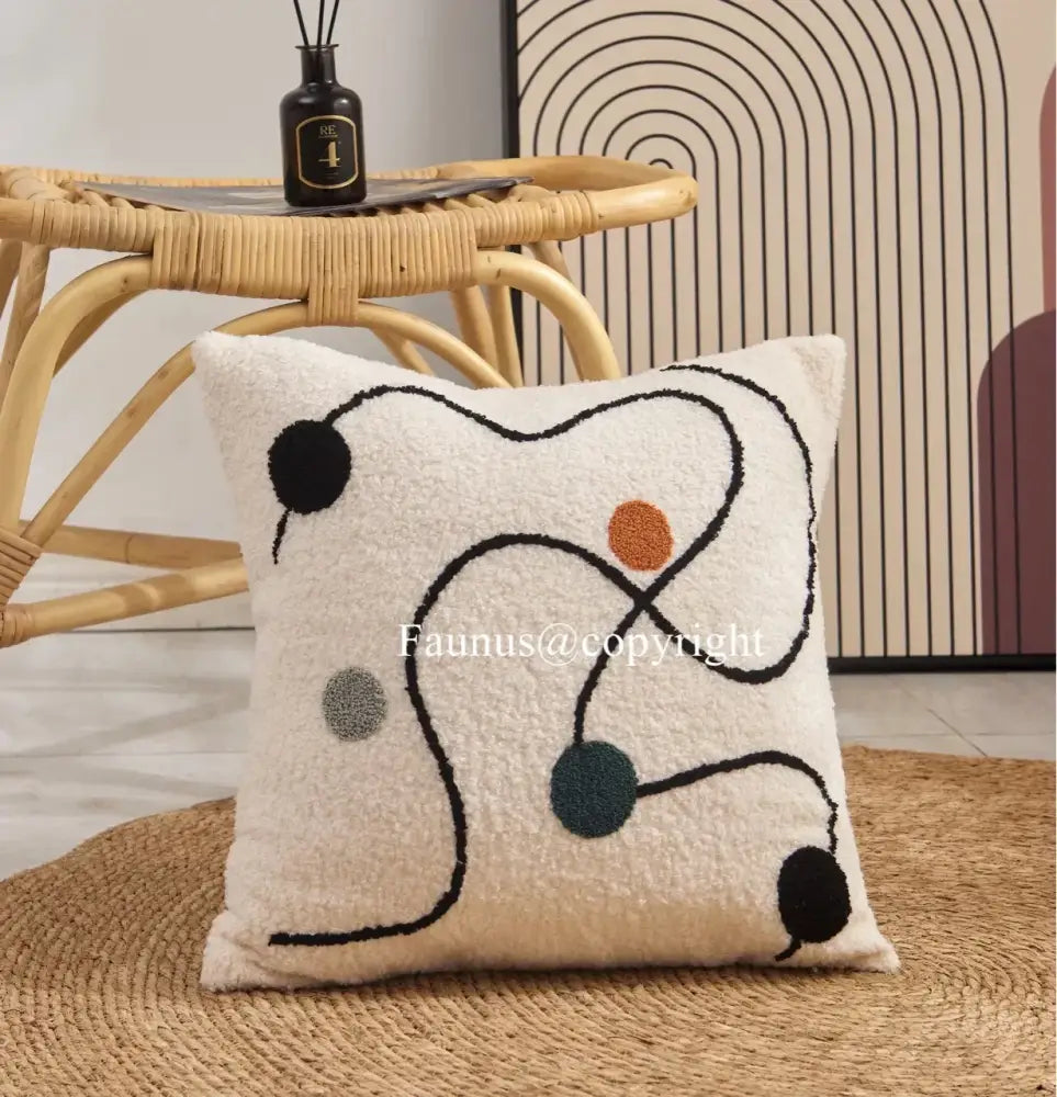 Cream cushion cover with plush fabric featuring geometric embroidery and colorful abstract decorbites geometric embroidery design