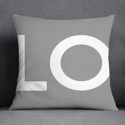 Gray pillow case with bold white lo lettering in modern font featuring decorbites geometric floral print design