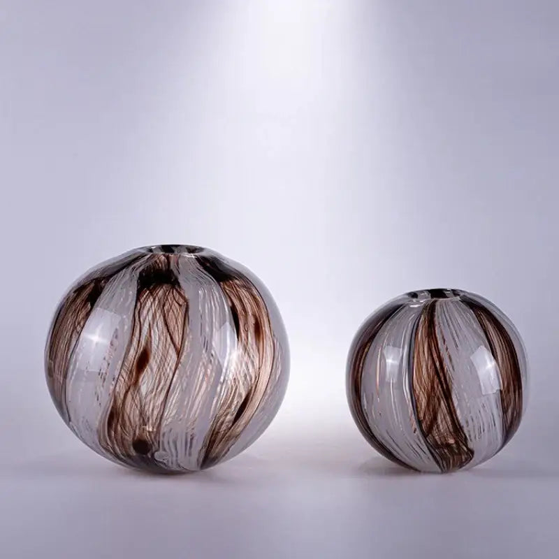 Two spherical decorbites geometric glass flower vases with swirling brown and clear patterns ideal for living room terrarium