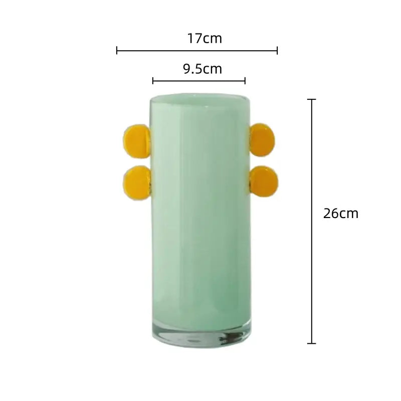 A tall translucent mint green geometric glass vase with bright yellow color patches for living room decorbites decor