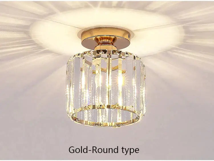 Gold-toned led chandelier with cylindrical design and vertical crystal prisms on polished brass base for dining room decorbites crystal led