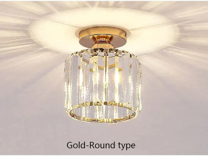 Gold-toned led chandelier with cylindrical design and vertical crystal prisms on polished brass base for dining room decorbites crystal led