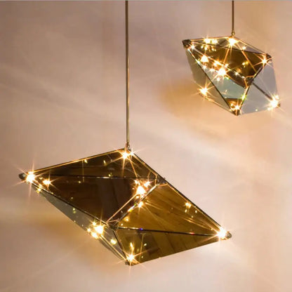 Gold geometric pendant lights with mirrored facets and warm led bulbs ideal for dining room led pendant lights