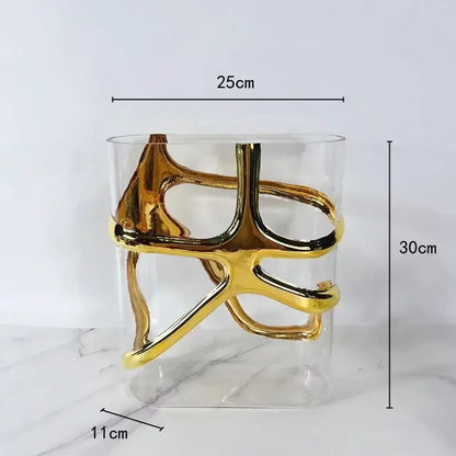 A modern transparent glass vase with an intricate gold-edged glass sculpture for living room decorbites decor