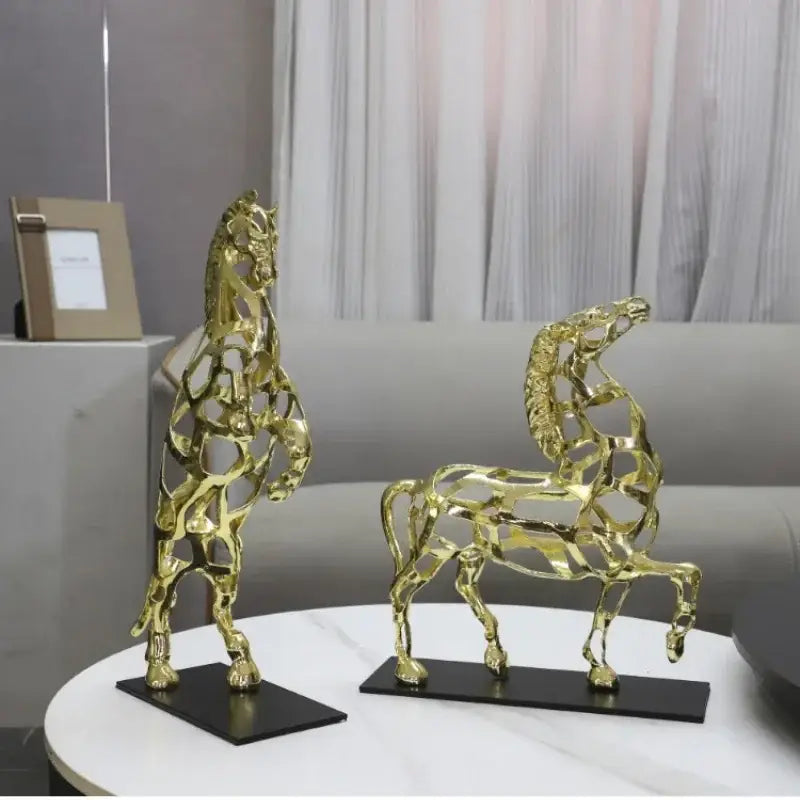 Two golden horse metal sculptures with geometric hollow design in standing and running poses for living room decorbites golden horse decor