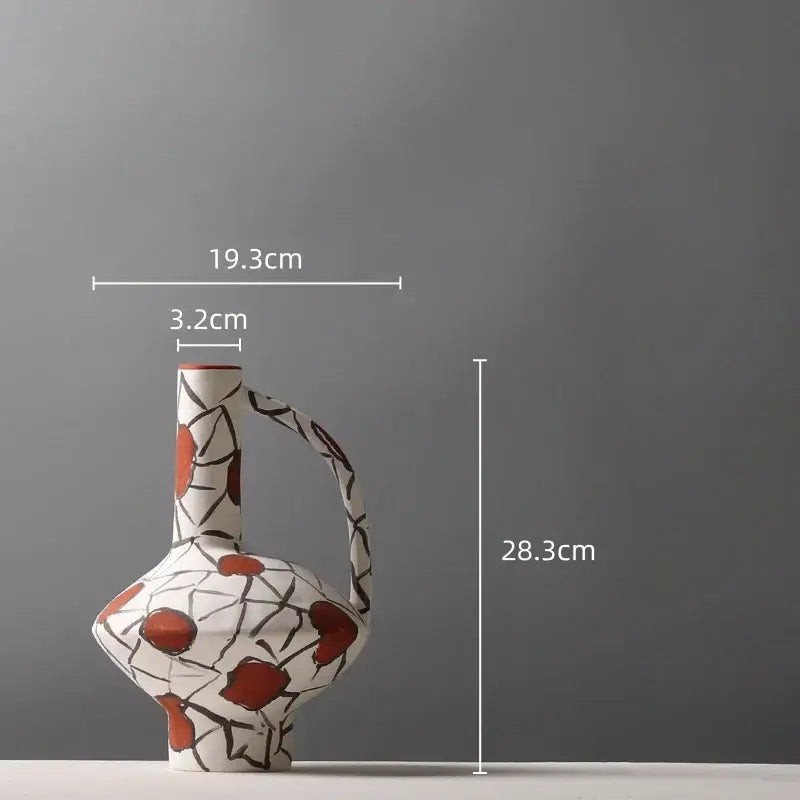 White ceramic geometric graffiti ceramic vase with curved handle and red circular motifs for terracotta living room decor