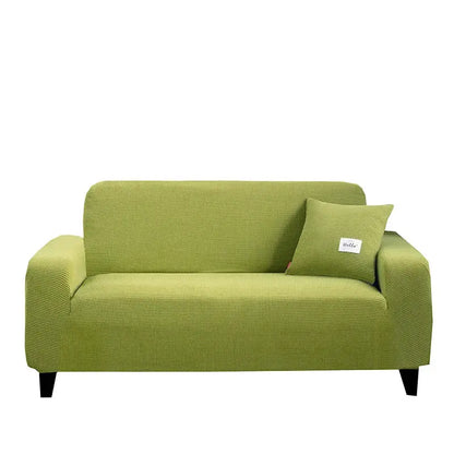 Green textured fabric sofa cover with matching pillow complementing geometric gray textured stretch sofa cover for living room