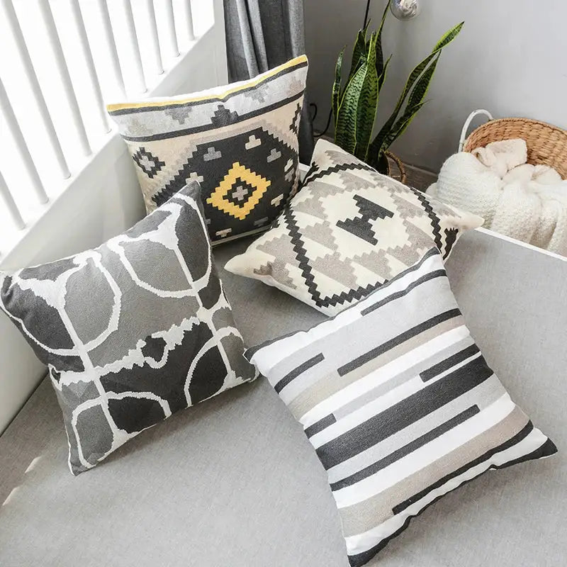 Four decorative grey embroidered cotton pillow covers with geometric and abstract patterns for living room decorbites decor