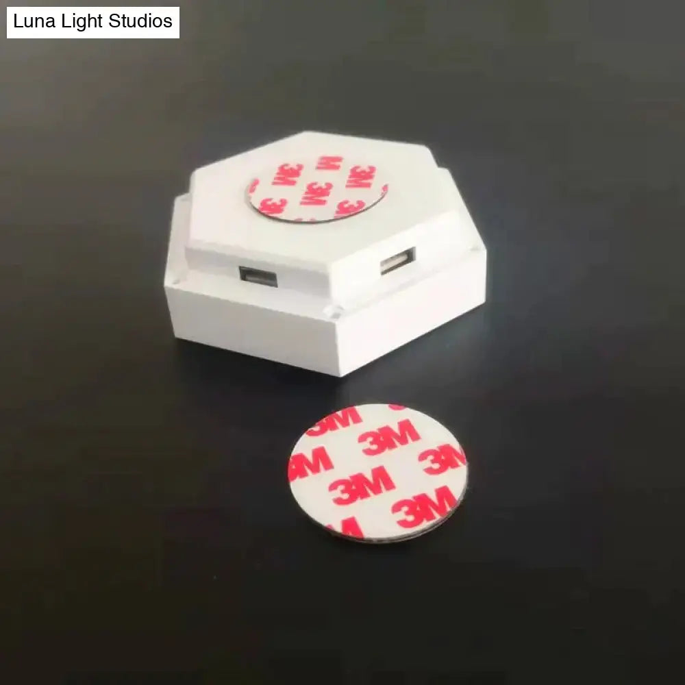 White hexagonal usb charger with two ports and 3m adhesive pad for mounting compatible with bluetooth app control
