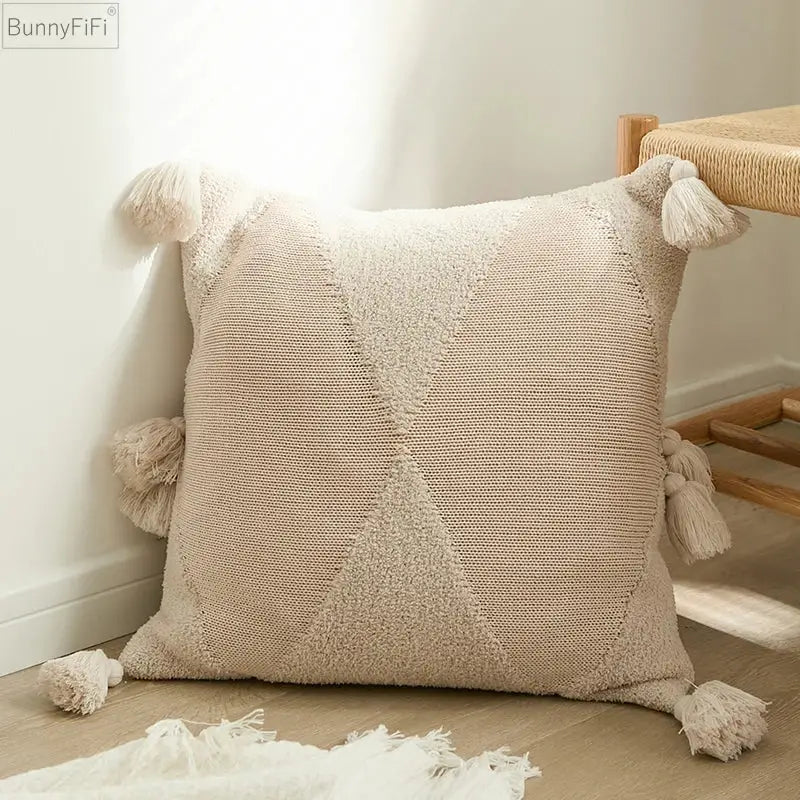 Beige woven cushion cover with textured geometric pattern and fluffy tassels for decorbites knitted mustard blue decor