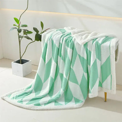A soft mint green and white geometric lamb wool blanket with plush sherpa lining for cozy bedroom decorbites geometric lamb throw