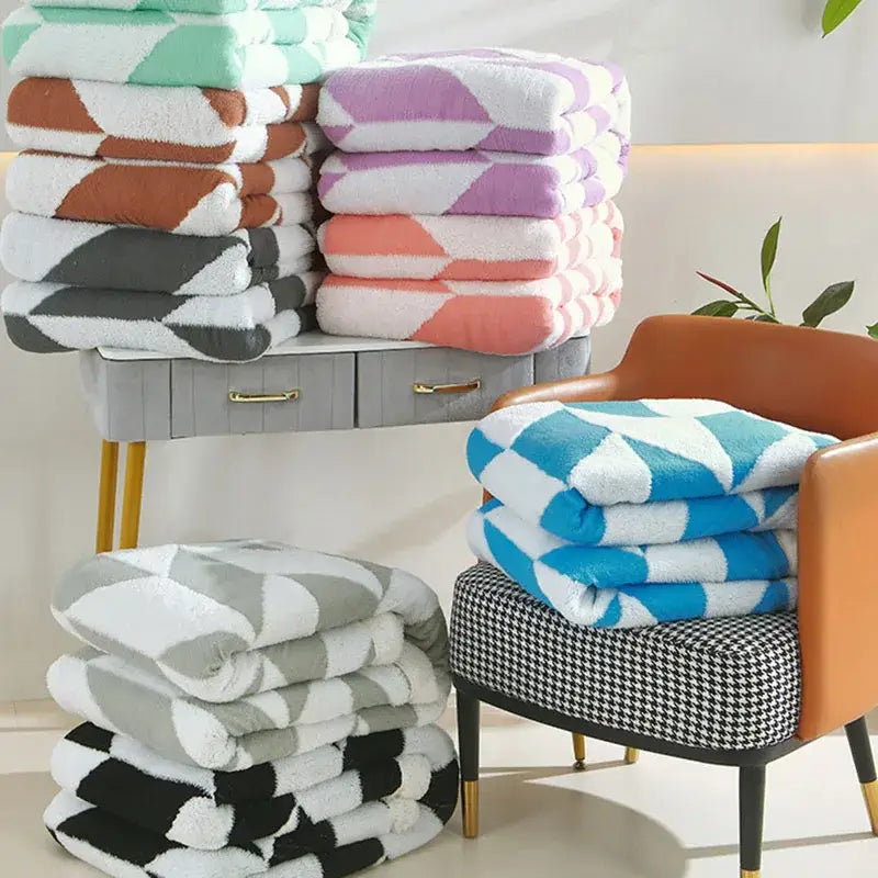 Stack of plush geometric lamb wool blankets in lavender white soft fleece perfect for cozy bedroom decorbites geometric lamb