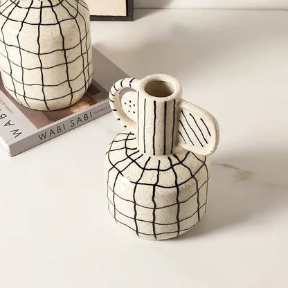 Cream-colored geometric line ceramic vase with black grid pattern and handle ideal for living room decorbites decor