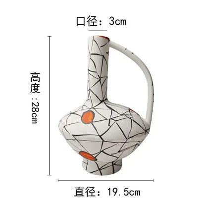 White ceramic vase with black crackle glaze and orange accents featuring an integrated handle for geometric line ceramic decorbites fringe decoration