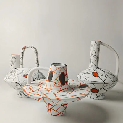 White ceramic vase with orange and black abstract crackle glaze from decorbites geometric line fringe decoration set