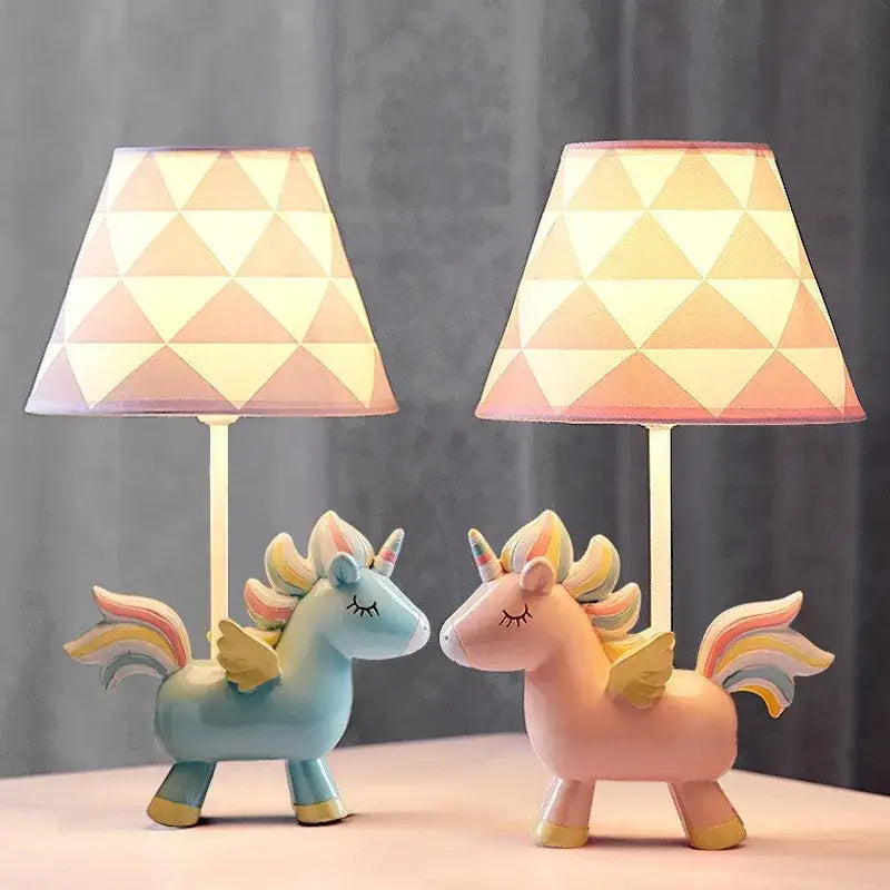 Two pastel pink and blue unicorn table lamps with geometric patterned shades for children’s bedroom decor