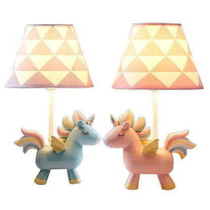 Two pastel pink and blue unicorn table lamps with geometric patterned shades for children’s bedroom decor