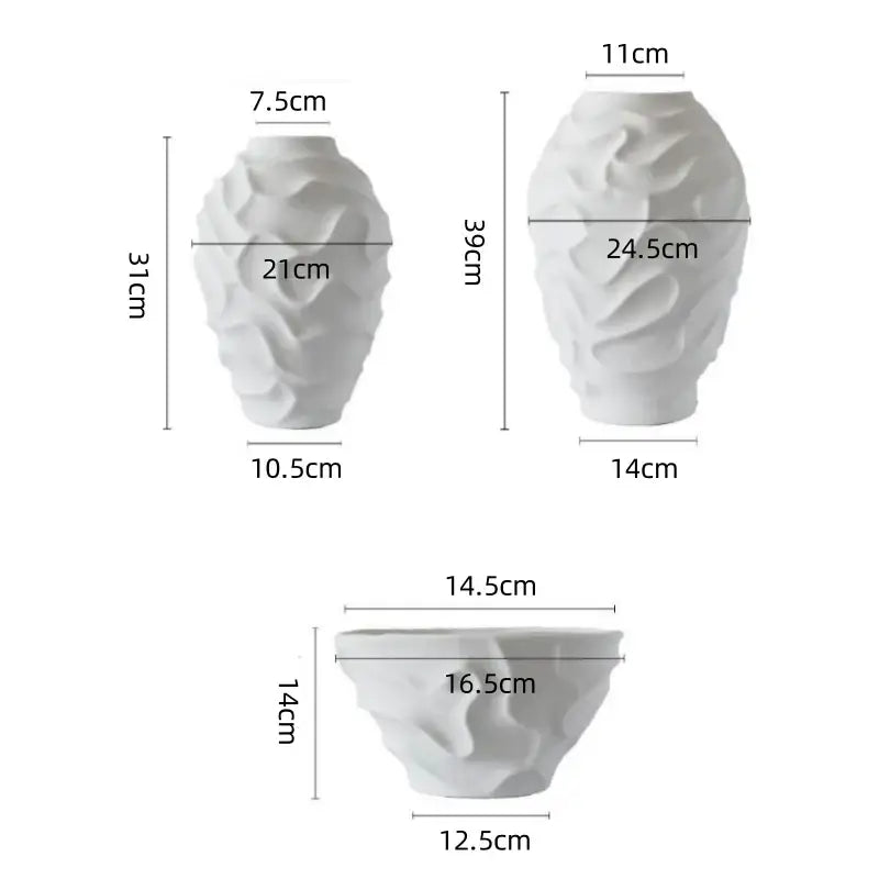 White ceramic vases with a textured geometric spiral design for elegant fruit platter and home decor display
