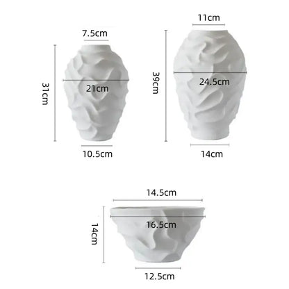 White ceramic vases with a textured geometric spiral design for elegant fruit platter and home decor display