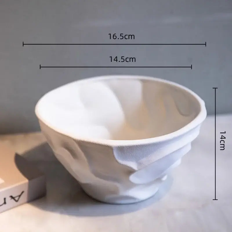 White ceramic bowl with textured sculpted surface and organic contours for geometric spiral fruit platter home decor