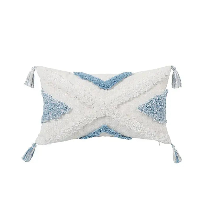 Rectangular white and light blue geometric tassel tufted pillow cover with woven pattern and corner tassels for living room