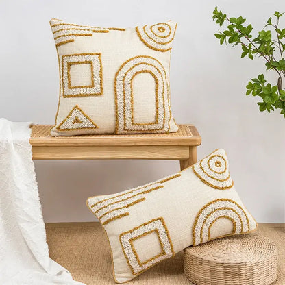 Cream-colored pillow covers with textured gold geometric tufted embroidery for living room decor by decorbites
