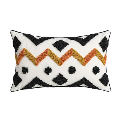 White rectangular pillow cover with black and orange zigzag pattern featuring geometric tufted accents for decorbites decor