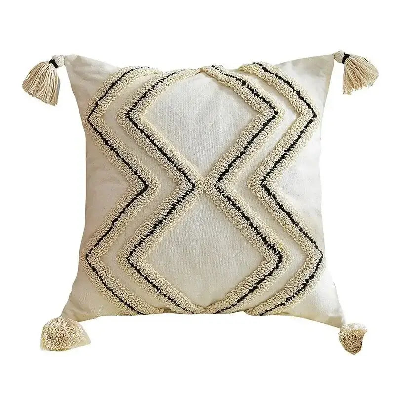 Cream-colored cushion cover with black and cream geometric tufted embroidery and tassels for decorbites geometric tufted decor