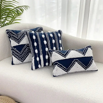 Three navy blue and white geometric tufted cushion covers with textured fabric and pom-pom tassel decorbites decor