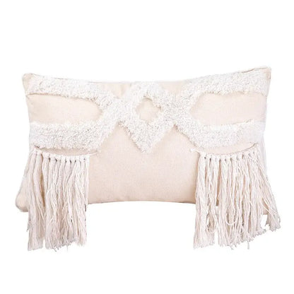 Cream-colored rectangular cushion cover with textured white woven geometric tufted pattern and long fringe decorbites geometric tufted