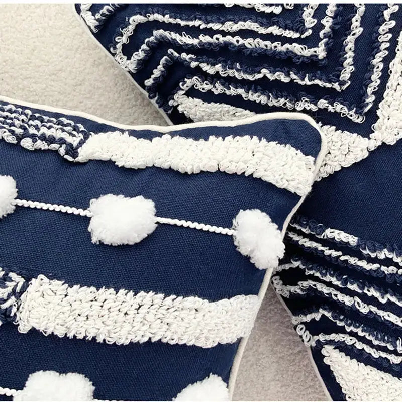 Navy blue geometric tufted cushion cover with white textured embroidery and fluffy pom-poms for living room decorbites decor