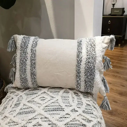Cream-colored cushion cover with gray and white woven stripes and tassels for decorbites geometric tufted living room decor