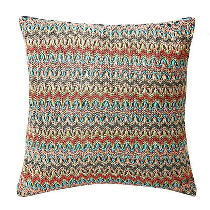 A vibrant multicolored geometric tufted cushion cover in red blue beige and green for living room decorbites decor