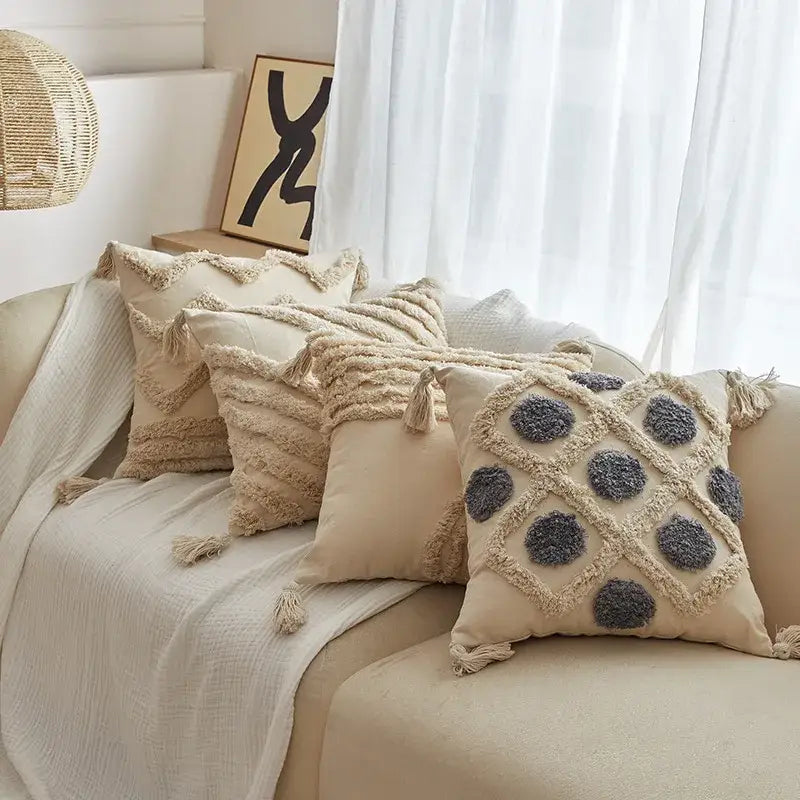Beige cushion cover with gray pom-pom accents and tassel trim from decorbites geometric tufted tassel collection for living room decor