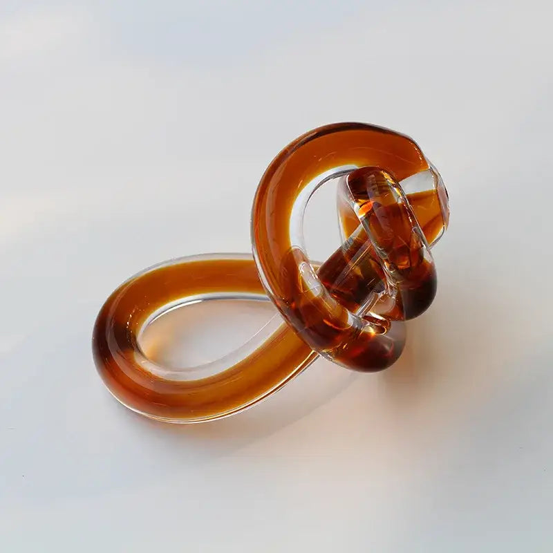 Translucent amber glass hair clip with glossy finish and twisted loop design for home decor by decorbites geometric glass