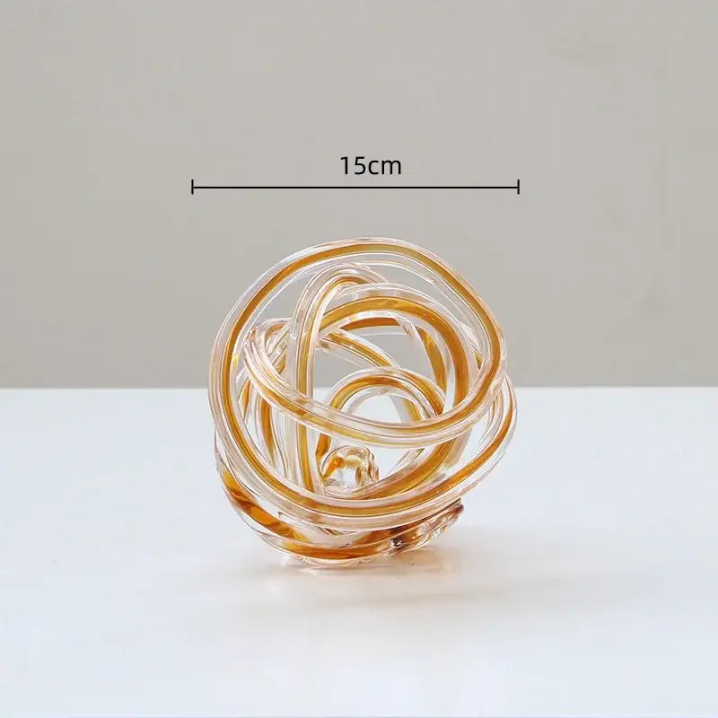 A translucent amber geometric wound glass twine sphere with swirling loops for living room decorbites decor
