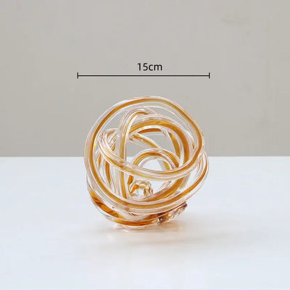 A translucent amber geometric wound glass twine sphere with swirling loops for living room decorbites decor