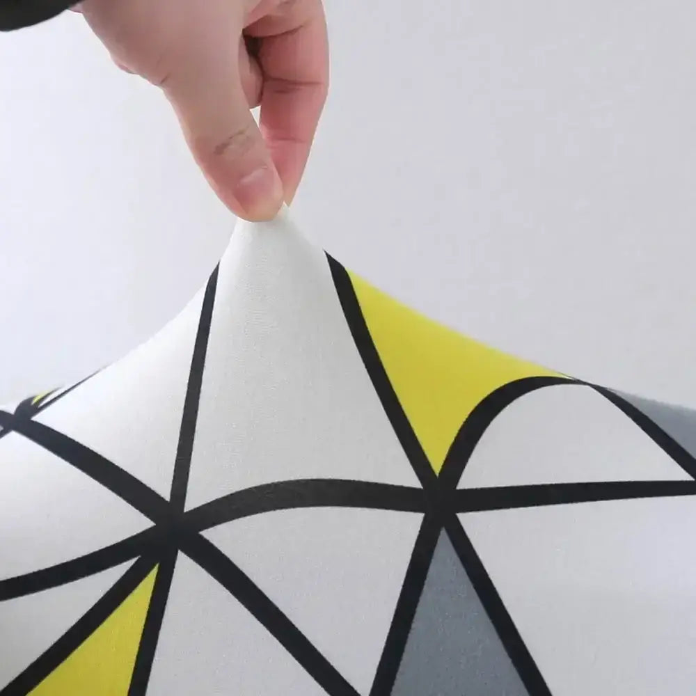 White geometric stretch sofa cover with bold black lines and yellow gray accents decorbites geometric stretch design