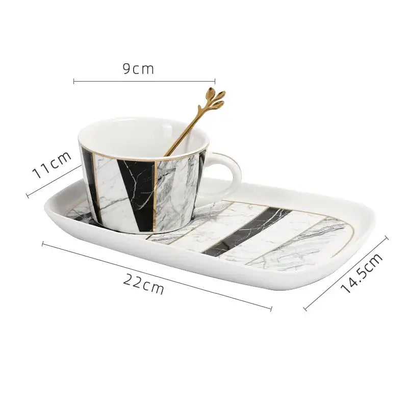 White ceramic cup with gilded marble texture black pattern and gold trim by decorbites on matching tray for luxury dining