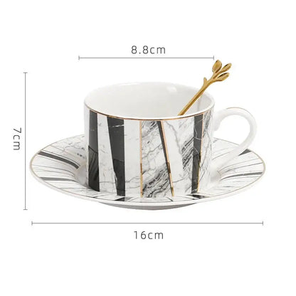 Elegant white ceramic cup with gilded marble texture black stripes and gold accents by decorbites with matching saucer