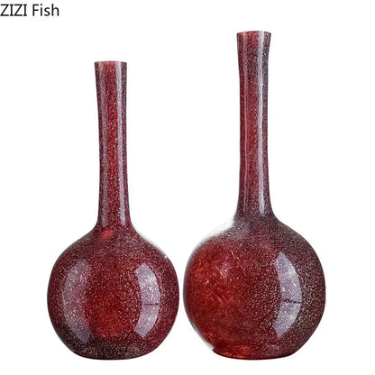 Two elegant gilded red glass vases with slender necks and textured surface featuring artificial flowers decorbites gilded red decor