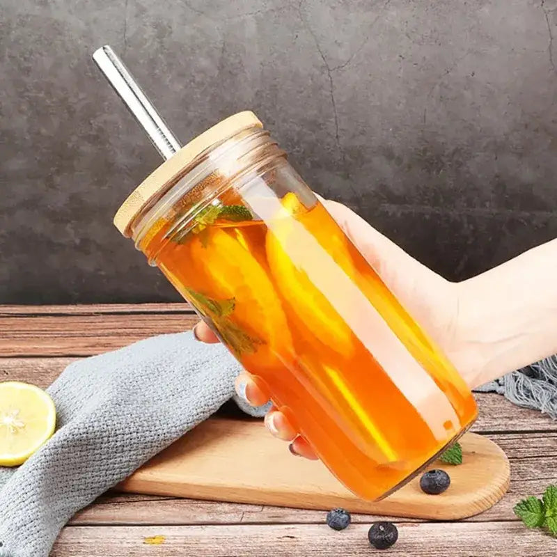 Clear glass decorbites glass boba smoothie cup with bamboo lid stainless steel straw filled with iced tea and lemon garnish