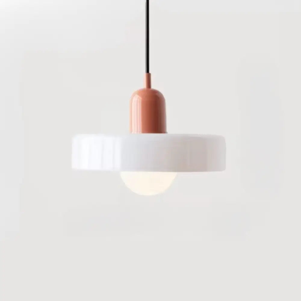 Minimalist glass pendant lighting with a matte terracotta cylindrical fixture and white ribbed glass shade bauhaus style