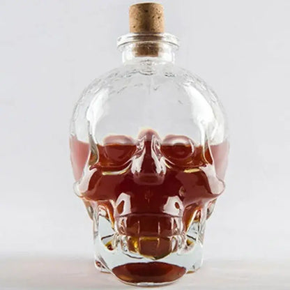 Clear glass skull bottle with cork stopper filled with amber liquid for kitchen crystal wine and vodka decanter